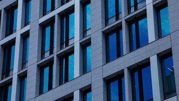 A timelapse of cloud reflecting the building in the business town long shot zoom video