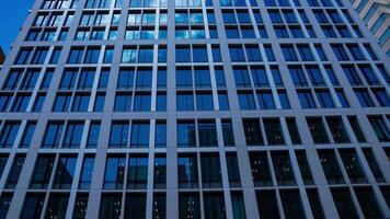 A timelapse of cloud reflecting the building in the business town panning video