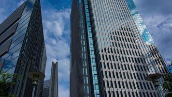 A timelapse of cloud reflecting the building in the business town wide shot panning video