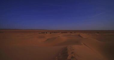 A panoramic sand dune near the desert camp at Mhamid el Ghizlane in Morocco wide shot video