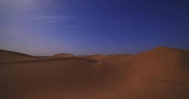 A panoramic sand dune of sahara desert at Mhamid el Ghizlane in Morocco wide shot panning video