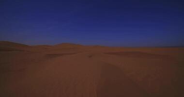 A panoramic sand dune of sahara desert at Mhamid el Ghizlane in Morocco wide shot video