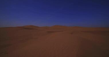 A panoramic sand dune of sahara desert at Mhamid el Ghizlane in Morocco wide shot video