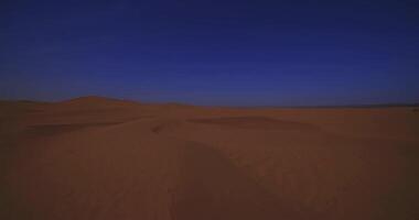 A panoramic sand dune of sahara desert at Mhamid el Ghizlane in Morocco wide shot video