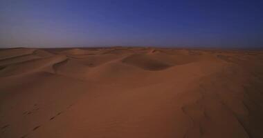 A panoramic sand dune of sahara desert at Mhamid el Ghizlane in Morocco wide shot video