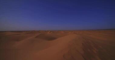 A panoramic sand dune of sahara desert at Mhamid el Ghizlane in Morocco wide shot panning video