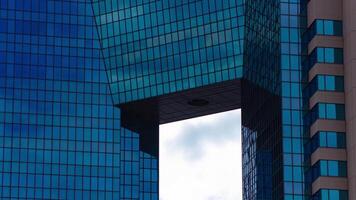 A timelapse of cloud reflecting an impressive building cloudy telephoto shot zoom video