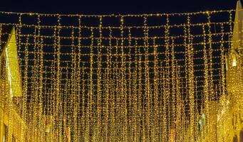 Festive hanging LED garlands against the background of the night sky. photo