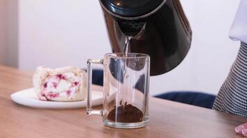 woman making coffee, eat Meringue roll cake with cream and raspberries, sitting in the kitchen or dining room video