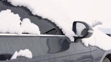 invierno clima y viaje preparación. congelado coche ventana. vista trasera espejo cubierto con escarcha y copos de nieve video