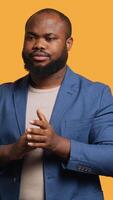 Vertical Approving joyful african american man happily clapping hands, ecstatic about accomplishments. Excited BIPOC person cheering, applauding, isolated over studio background, camera A video