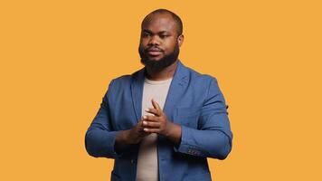 Approving joyful african american man happily clapping hands, ecstatic about accomplishments. Excited BIPOC person cheering, applauding, isolated over studio background, camera A video