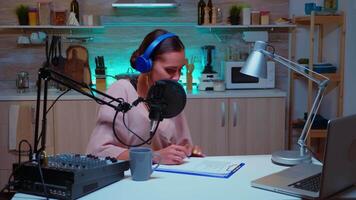 Host of night show speaking and taking notes on clipboard. Creative online show On-air production internet broadcast host streaming live content, recording digital social media communication video