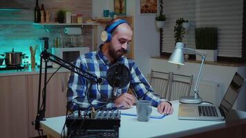 Social media analyst speaking on microphone during podcast in home studio with neon light in the background. Creative online show On-air production internet broadcast host streaming live content, recording digital social media communication video