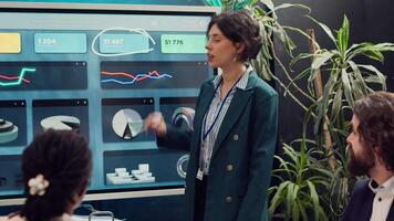 Startup team reviewing the organization position within the market, conducting an analysis or benchmarking exercises. Enterprise colleagues discuss activities for organizational growth. Camera A. video