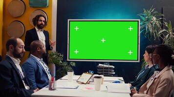 Sales management team working with isolated copyspace display in a briefing meeting, sharing ideas and practices to improve workflow. Organization affiliates gathered in a conference. Camera B. video