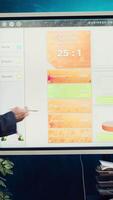 Sales manager creates a presentation to pitch in a new strategy for development, using interactive board to make his staff members understand the objectives. Business planning meeting. Camera A. video