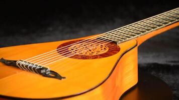 Ancient pear guitar manufactured by a luthier gyrating on black velvet video