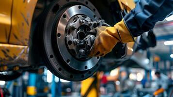 Car mechanic changing wheel in auto repair shop. repairing a cars brake system. His gloved hands focus on the brake disc, ensuring safety and precision photo