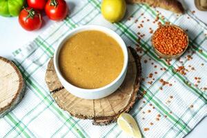 Wooden Slice With a Bowl of Peanut Butter photo