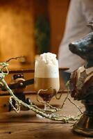 Glass of Beer on Wooden Table photo