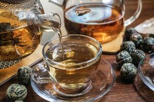 Pouring Tea Into Glass Cup photo