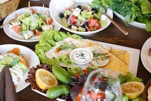 Wooden Table Displaying Plates of Delicious Food photo