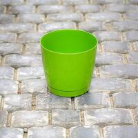 Green Cup on Stone Floor photo