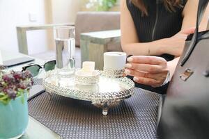 Woman Sitting at Table With Tray and Glass of Water photo