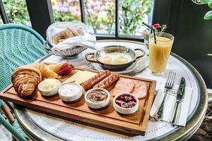 Table Setting With a Plate of Food and Glass of Orange Juice photo