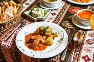 Table Adorned With Plates of Food and Bowls of Soup photo