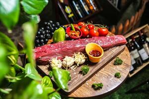 Wooden Cutting Board With Meat and Vegetables photo