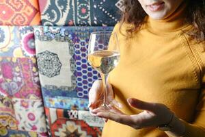 Woman in Yellow Sweater Holding Wine Glass photo