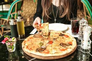 Woman Sitting at Table With Pizza photo