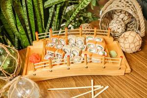 Wooden Tray Filled With Sushi and Chopsticks photo