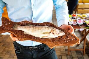 Man Holding a Fish in His Hands photo