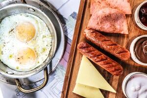 Scrambled Eggs, Sausages, and Cheese Cooking in a Pan photo