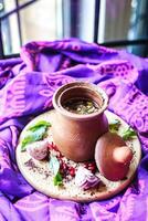 Bowl of Soup on Plate on Purple Blanket photo