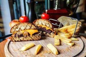 Cheeseburger and Fries on Wooden Board photo