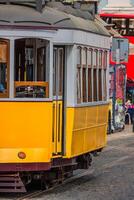 Romantic yellow tramway - main symbol of Lisbon, Portugal photo