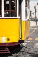 Romantic yellow tramway - main symbol of Lisbon, Portugal photo
