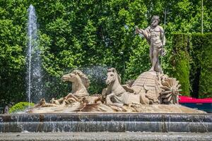 Fountain of Neptune Fuente de Neptuno one of the most famous landmark of Madrid, Spain photo