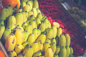 Freshly harvested collection of organic fruits as background.colorful fruits on market stand photo