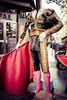 Beautiful traditional red flamenco dress hanged for display in a shop Spain photo