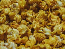 Delicious sweet popcorn, close-up shot for dessert food background. photo