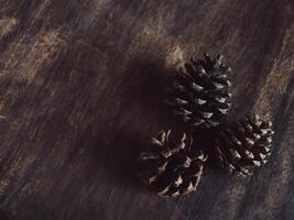 Dried pine cones on old wood and vintage style copy space. photo