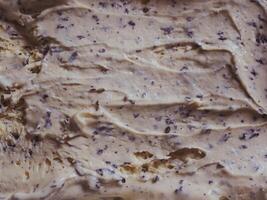 Delicious vanilla chocolate chip ice cream texture for food or dessert background, close-up. photo