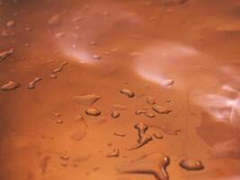 Light reflection on aluminum floor with water drops, dark background photo