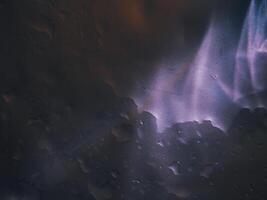 Light reflection on aluminum floor with water drops, dark background photo