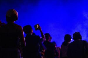 Group of people having fun at music concert photo